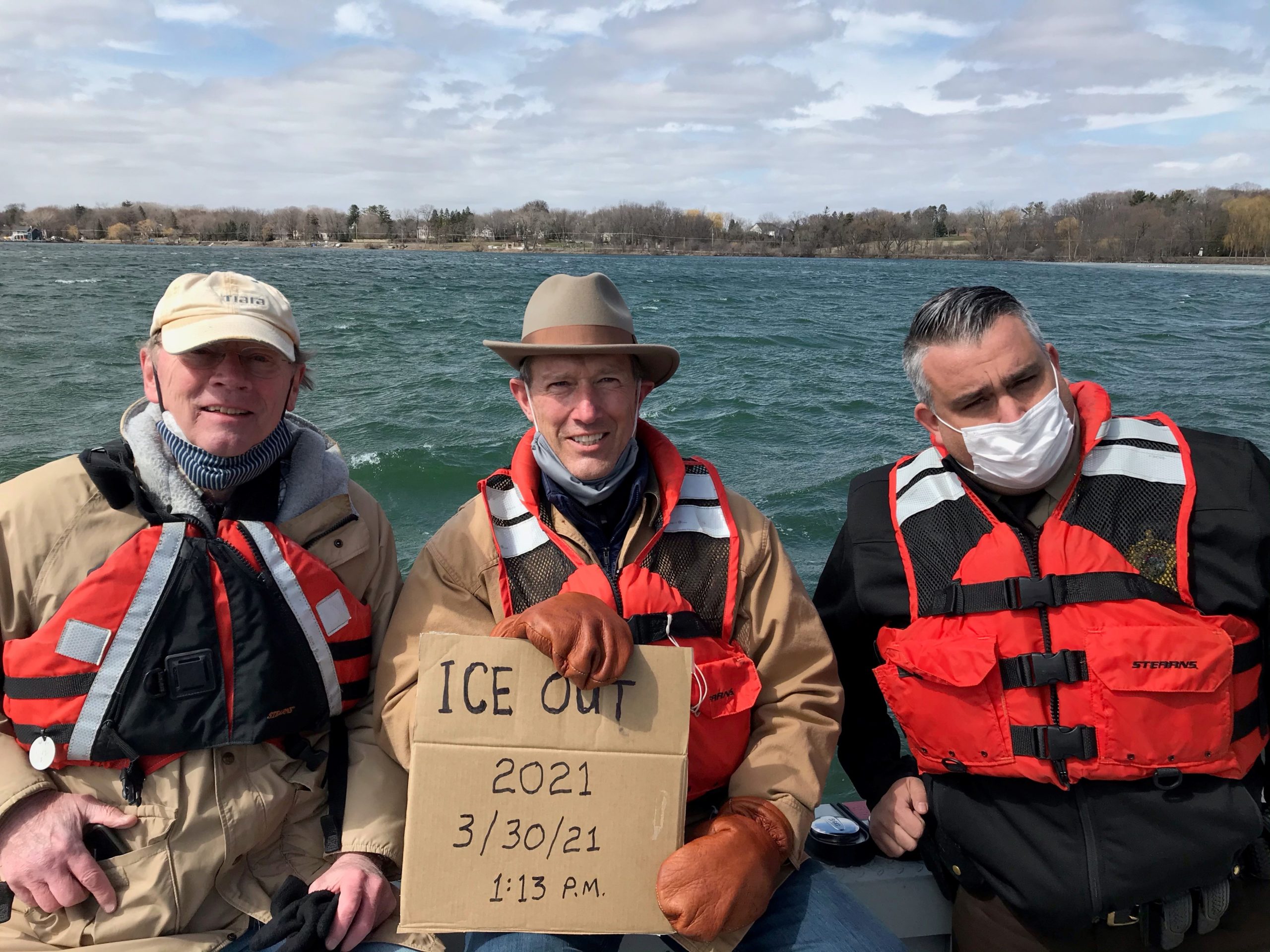Freshwater board members Tom Skramstad (left) and Wade Campbell, with Lt. Dave Hutchinson of the Henn. Co. Water Patrol declare ice-out on Lake Minnetonka.