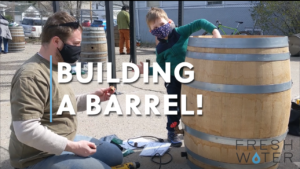 Farther and son building a rain barrel