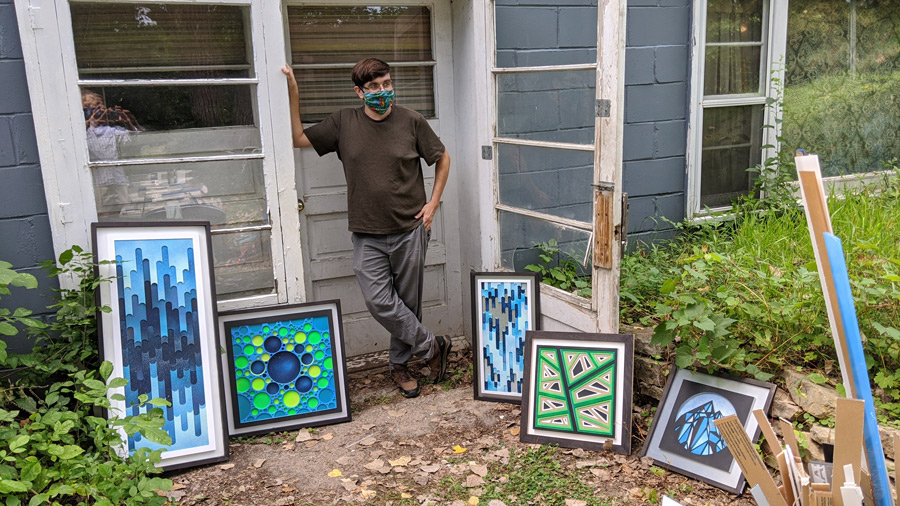 art1 artist with various framed artwork