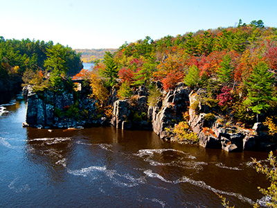 River flowing through cliffs and fall foliage