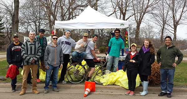 Group of young adults outside prepping for a cleanup